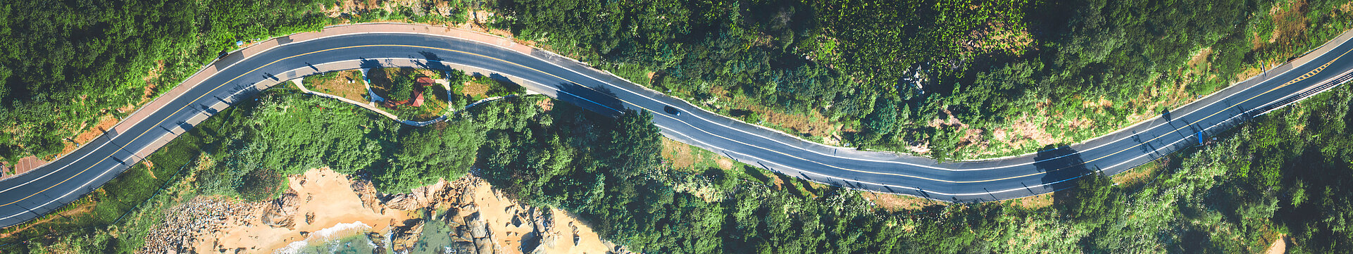 Aerial view of the sandy beach and road