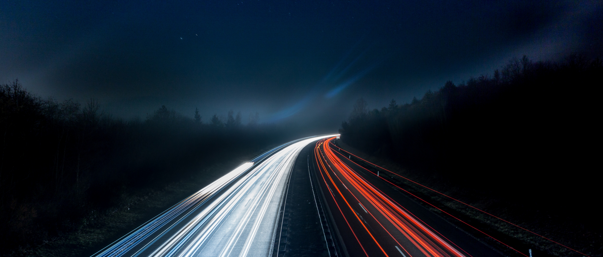 Road at night with streaks of light from headlights Road at night with streaks of light from headlights